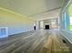 Spacious living room featuring wood flooring, white trim, and a cozy fireplace at 614 E Main Ave, Taylorsville, NC 28681