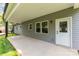 View of the outdoor porch area with gray siding, door access, and view of the backyard at 627 West Main Ext, Lincolnton, NC 28092
