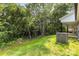 Scenic backyard with lush green grass, mature trees, and an A/C unit near the house at 627 West Main Ext, Lincolnton, NC 28092