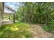 Expansive backyard with vibrant green grass and mature trees, providing privacy at 627 West Main Ext, Lincolnton, NC 28092