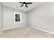 Well-lit bedroom with neutral decor, carpet, ceiling fan, and bright natural light at 627 West Main Ext, Lincolnton, NC 28092