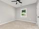 Light-filled bedroom with carpeted floor, fan, and a window providing ample natural light at 627 West Main Ext, Lincolnton, NC 28092
