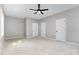 Large bedroom features neutral carpet, grey walls, ceiling fan, and multiple closets at 627 West Main Ext, Lincolnton, NC 28092