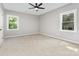 Spacious bedroom offers neutral walls, soft carpeting and a ceiling fan for added comfort at 627 West Main Ext, Lincolnton, NC 28092
