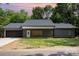 Charming one-story home featuring a gray exterior, black garage door, and well-manicured lawn at 627 West Main Ext, Lincolnton, NC 28092