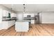 Modern kitchen with island, marble countertops, stainless steel appliances, and light wood floors at 627 West Main Ext, Lincolnton, NC 28092