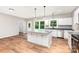 New kitchen boasts white cabinets, a central island with marble countertop and wood floors at 627 West Main Ext, Lincolnton, NC 28092