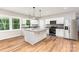 Bright kitchen features an island with marble countertops, stainless steel appliances, and wood floors at 627 West Main Ext, Lincolnton, NC 28092
