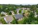 An aerial view captures the backyard of a home with a screened-in porch and patio for outdoor enjoyment at 708 Ardent Trl, Belmont, NC 28012