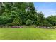 Landscaped backyard featuring manicured lawn and flower beds creating a serene outdoor space at 708 Ardent Trl, Belmont, NC 28012
