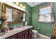 Well-lit bathroom with green walls, granite countertop, decorative mirror and vanity at 708 Ardent Trl, Belmont, NC 28012