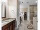 Spacious bathroom featuring double vanity sinks, tiled floor, and walk-in closet at 708 Ardent Trl, Belmont, NC 28012