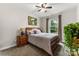 Bedroom featuring a wooden bed frame, neutral bedding, and a window with curtains at 708 Ardent Trl, Belmont, NC 28012