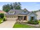 Charming home with a well-manicured lawn and a cozy front porch with stone accents at 708 Ardent Trl, Belmont, NC 28012
