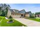 Lovely home featuring a long driveway, attached garage, and beautiful landscaping at 708 Ardent Trl, Belmont, NC 28012