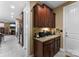 Hallway with granite countertop, brown cabinets, tile flooring and stainless steel appliances at 708 Ardent Trl, Belmont, NC 28012