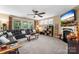 Spacious living room features a ceiling fan, a fireplace, and large windows at 708 Ardent Trl, Belmont, NC 28012