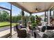 Relaxing screened patio with comfortable seating and ceiling fan overlooking backyard at 708 Ardent Trl, Belmont, NC 28012