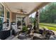 Cozy screened-in porch featuring comfortable seating and a ceiling fan with views of the backyard at 708 Ardent Trl, Belmont, NC 28012