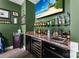 Wet bar featuring a wine fridge, sink, countertop, and wall shelves stocked with glassware at 708 Ardent Trl, Belmont, NC 28012