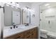 Updated bathroom with a double vanity, modern fixtures and a walk-in shower with frameless glass door at 712 Mallard Head Ln, Mooresville, NC 28117