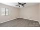 Bright bedroom with wood-look flooring and a window letting in natural light at 712 Mallard Head Ln, Mooresville, NC 28117