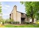 Multi-story condo building surrounded by lush green lawn and mature trees at 712 Mallard Head Ln, Mooresville, NC 28117