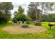 Outdoor firepit area featuring chairs, picnic table, and green space at 712 Mallard Head Ln, Mooresville, NC 28117