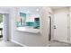 Bright kitchen view features white cabinets, stainless appliances, and turquoise backsplash at 712 Mallard Head Ln, Mooresville, NC 28117