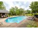 Beautiful community pool area surrounded by lush trees and landscaping at 712 Mallard Head Ln, Mooresville, NC 28117