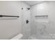 Sleek glass enclosed shower with white marble-look tile, and a built in shower niche for storage at 712 Mallard Head Ln, Mooresville, NC 28117