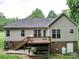 Backyard with stairs leading to the deck, and storage below deck at 727 Cove Rd, Gastonia, NC 28052