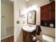 Cozy bathroom featuring a brown cabinet, unique faucet, and lovely wall art at 727 Cove Rd, Gastonia, NC 28052