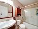 Bathroom with cabinet storage, white tiling, and shower with sliding glass doors at 727 Cove Rd, Gastonia, NC 28052