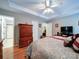 Spacious bedroom featuring hardwood floors, a ceiling fan, and a comfortable bed at 727 Cove Rd, Gastonia, NC 28052