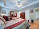 Spacious bedroom featuring hardwood floors, a ceiling fan, and a comfortable bed at 727 Cove Rd, Gastonia, NC 28052