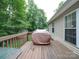 Wood deck featuring an outdoor grill and views of the well-maintained backyard at 727 Cove Rd, Gastonia, NC 28052