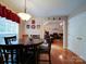 Cozy dining room features hardwood floors, round table, and a view into the inviting living space at 727 Cove Rd, Gastonia, NC 28052