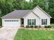 Charming single-story home featuring a well-manicured lawn and an attached two-car garage at 727 Cove Rd, Gastonia, NC 28052