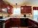 Well-appointed kitchen with granite countertops, undermount sink, and wood cabinets with under cabinet lighting at 727 Cove Rd, Gastonia, NC 28052