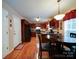Spacious kitchen with wooden cabinetry, hardwood floors, stainless steel appliances and dining area at 727 Cove Rd, Gastonia, NC 28052