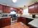 Functional kitchen with stainless steel appliances, granite counters, and wood cabinets for ample storage at 727 Cove Rd, Gastonia, NC 28052