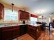 Kitchen with granite countertops, undermount sink, wood cabinets, and a view into the dining area at 727 Cove Rd, Gastonia, NC 28052
