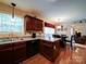 Open kitchen area flowing into the dining room, featuring granite counters and stainless appliances at 727 Cove Rd, Gastonia, NC 28052