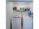 Bright laundry area featuring modern appliances, storage shelves and cleaning supplies at 727 Cove Rd, Gastonia, NC 28052