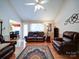 Spacious living room with vaulted ceilings, ceiling fan, hardwood floors, and plenty of natural light at 727 Cove Rd, Gastonia, NC 28052