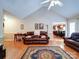 Inviting living room with hardwood floors, vaulted ceilings, neutral paint, and a ceiling fan at 727 Cove Rd, Gastonia, NC 28052