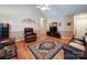 Cozy living room with hardwood floors, vaulted ceiling, ceiling fan, and leather furniture at 727 Cove Rd, Gastonia, NC 28052