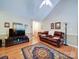 Bright living room featuring hardwood floors, high ceilings, neutral paint, and comfortable leather seating at 727 Cove Rd, Gastonia, NC 28052
