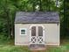 Charming backyard shed with double doors, offering ample storage space and adding a touch of rustic charm to the property at 727 Cove Rd, Gastonia, NC 28052